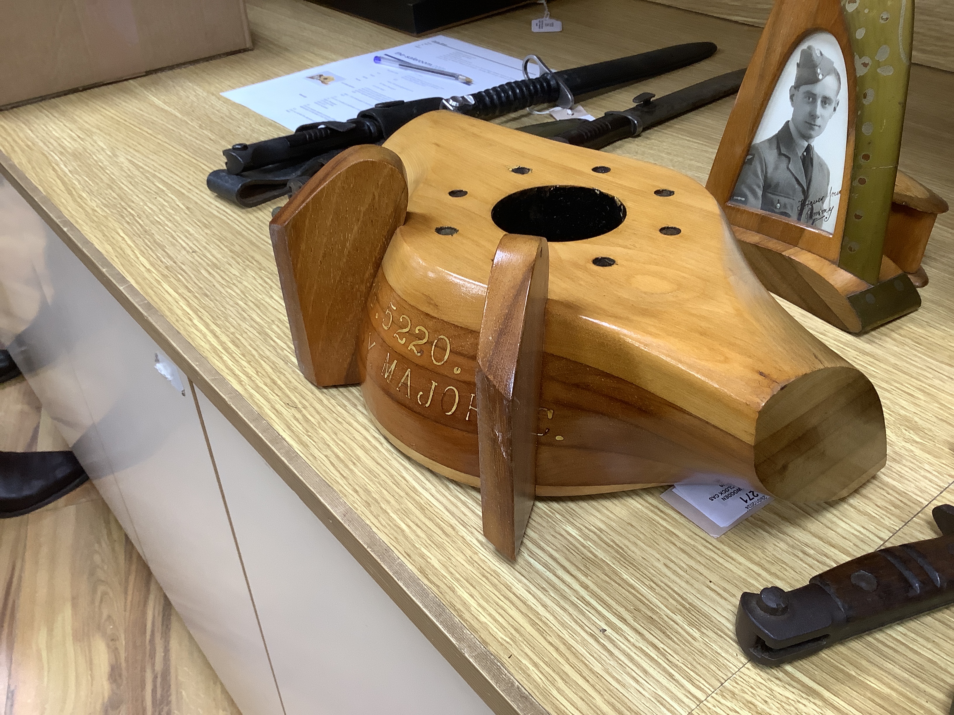 A WWII wooden propeller clock case, reputedly from a Spitfire related photo frame housing a black and white photograph of a soldier together with a trinket box, 35cm wide